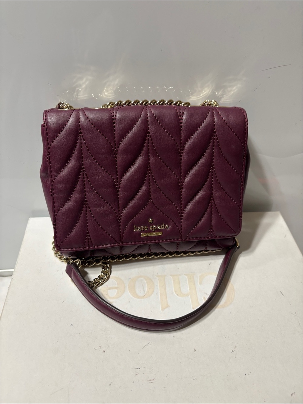 kate spade plum shoulder bag with gold chain hardware. Preowned but never used